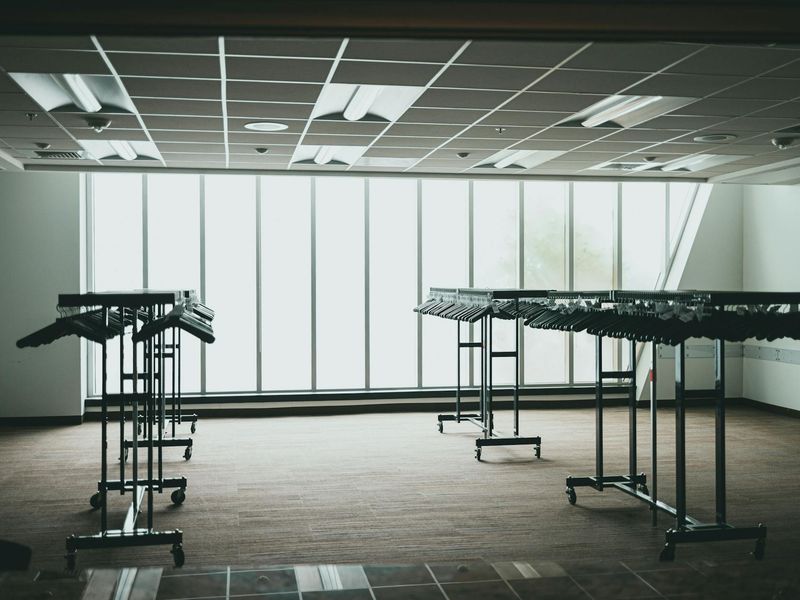 Spacious minimalist room with large windows for exercise.